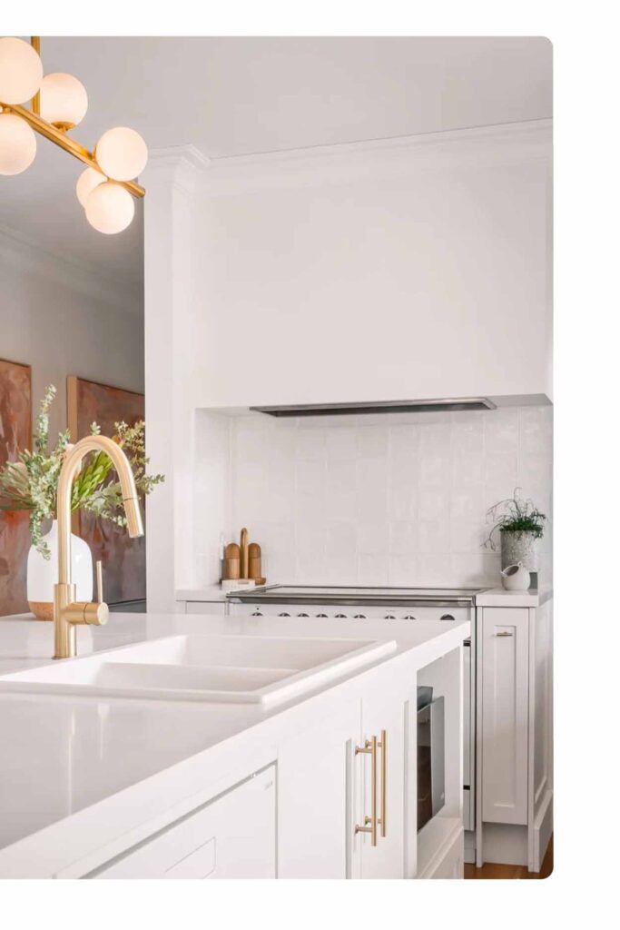 Modern white kitchen benchtop Sydney with integrated sink, gold fittings and timeless cabinetry design