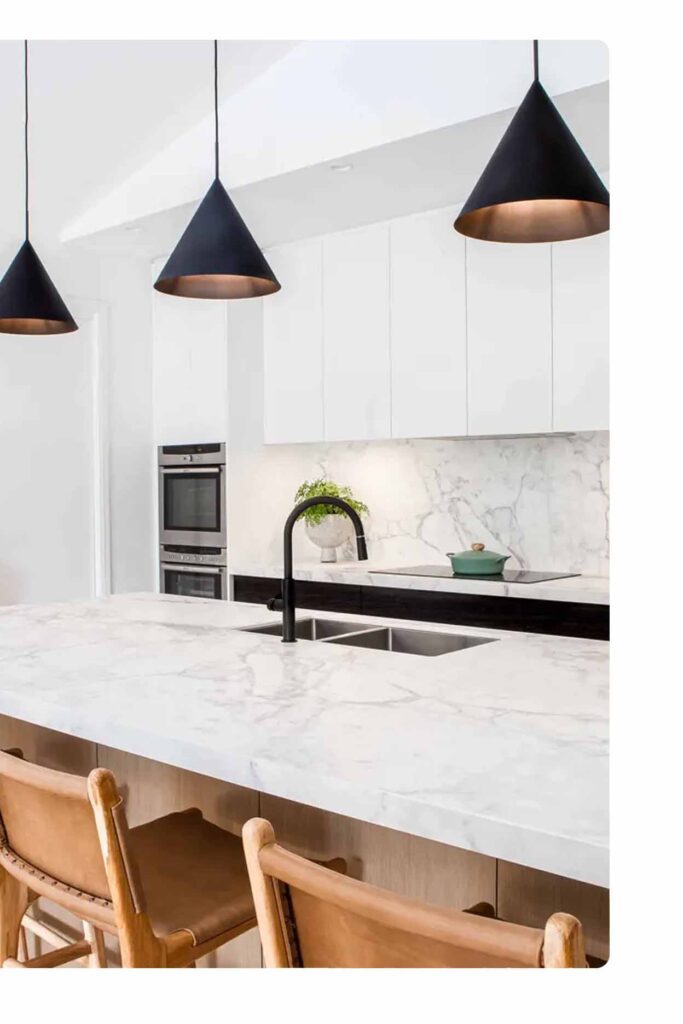 Contemporary kitchen layout Sydney with marble island, black tapware and pendant lighting