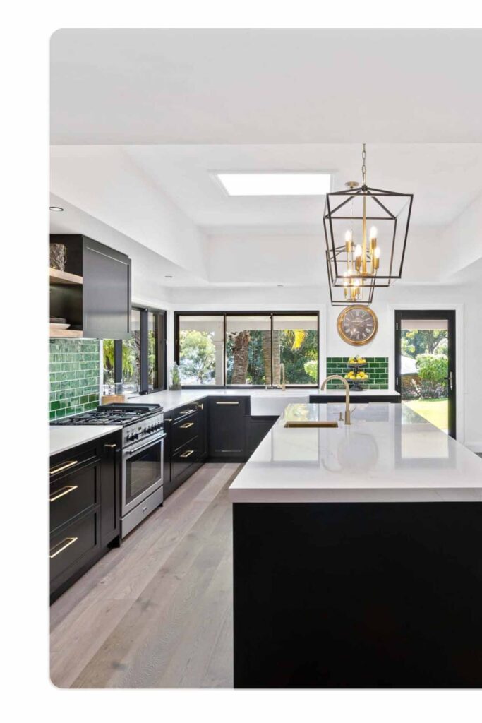 Modern kitchen renovation with black cabinetry, engineered stone benchtop, and green tiled splashback in Sydney.